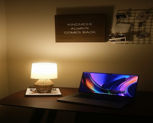 modern warm desk lamp with soft light next to a computer